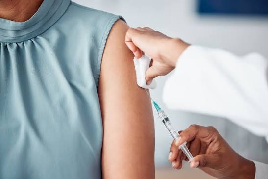 Nurse administering a flu vaccination into a patient's arm